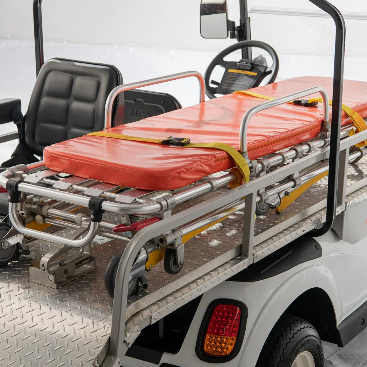 Golf cart with a stretcher attached, likely for medical or emergency use.