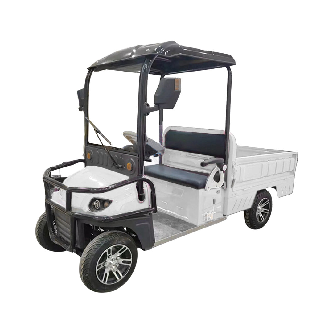 ocean cartz three-quarter front studio shot of a white utility electric vehicle with a short flatbed, set against a pure white background. This two-seater electric work cart features a black roof, black seats, a robust black front brush guard, and a small windshield with a wiper. The electric utility truck has custom silver alloy wheels and is designed for commercial hauling and property maintenance tasks.