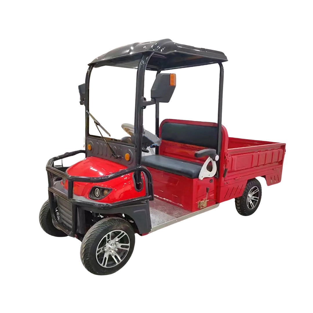 ocean cartz three-quarter front studio shot of a red utility electric vehicle with a short flatbed, set against a pure white background. This two-seater electric work cart features a black roof, black seats, a robust black front brush guard, and a small windshield with a wiper. The electric utility truck has custom silver alloy wheels and is designed for commercial hauling and property maintenance tasks.