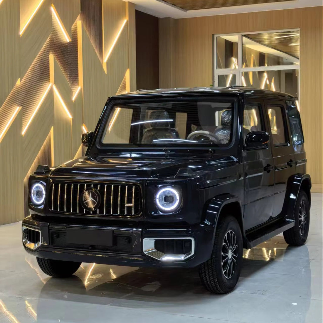 Black Mercedes-Benz SUV in a showroom with decorative wall and floor.