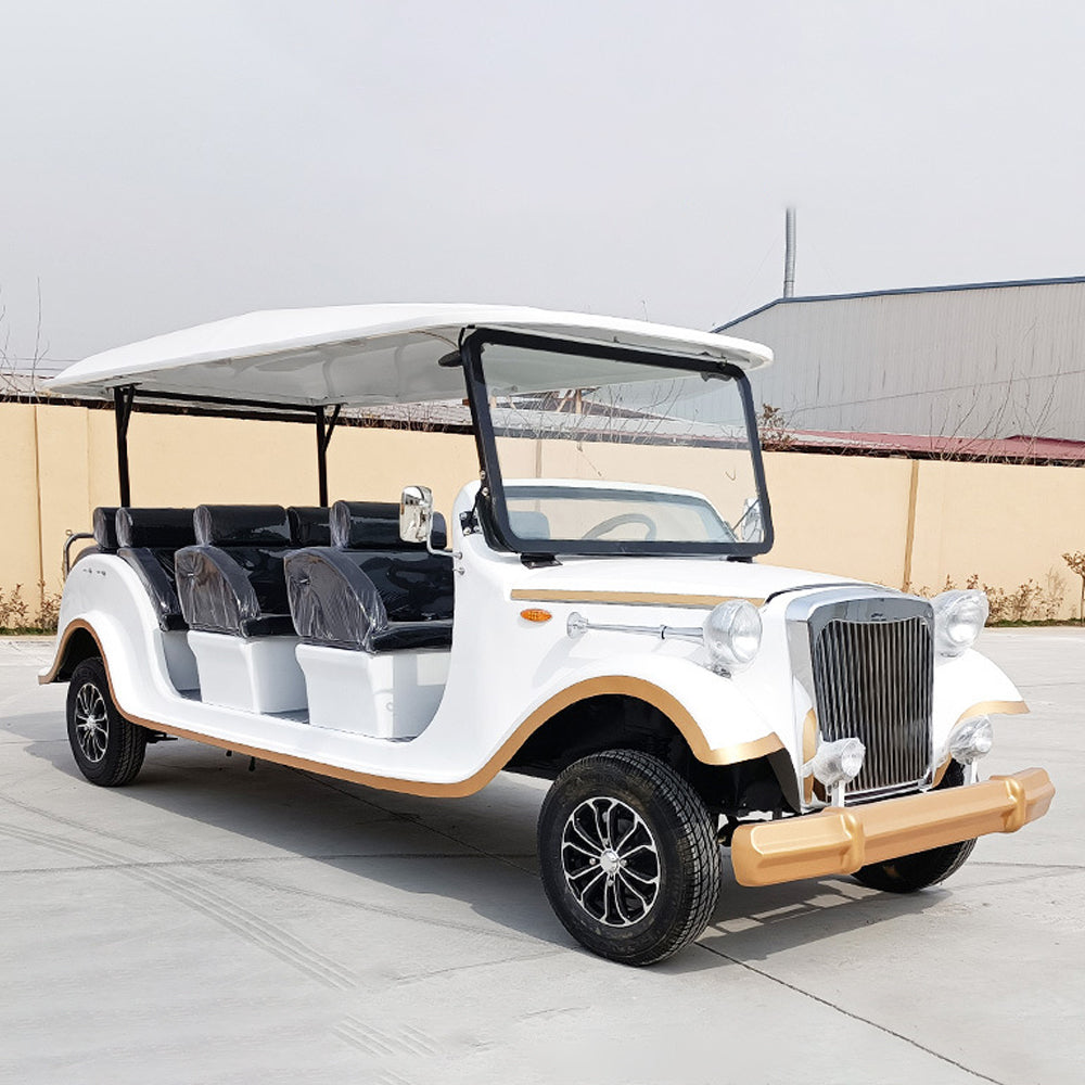 Red electric vehicle on a road with trees in the background