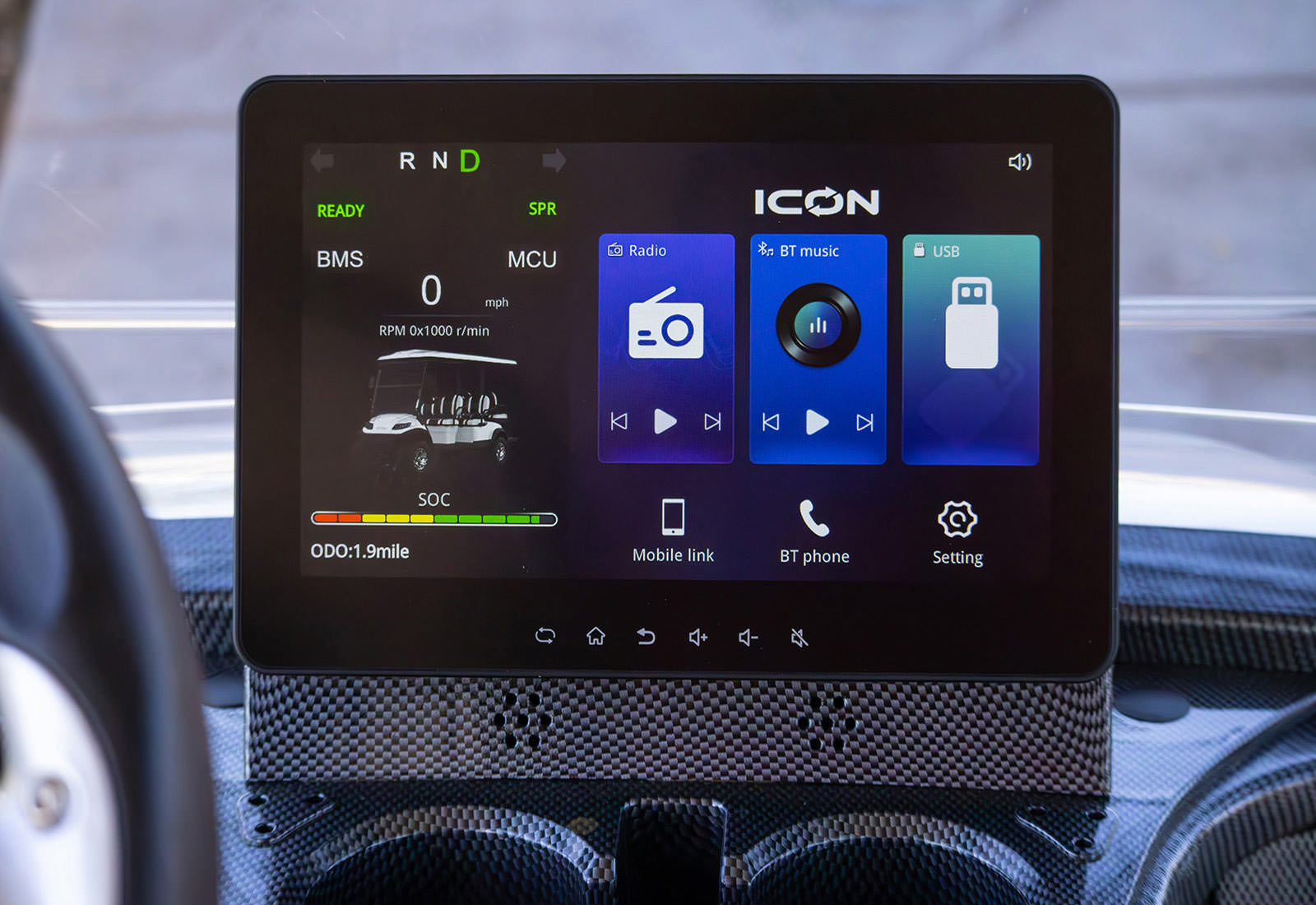 Car infotainment system display with ICON branding on a blurred background