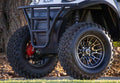 Close-up of a four-wheeler with large off-road tires and a black rim.