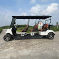 Electric golf cart with four seats on a paved path with a scenic background