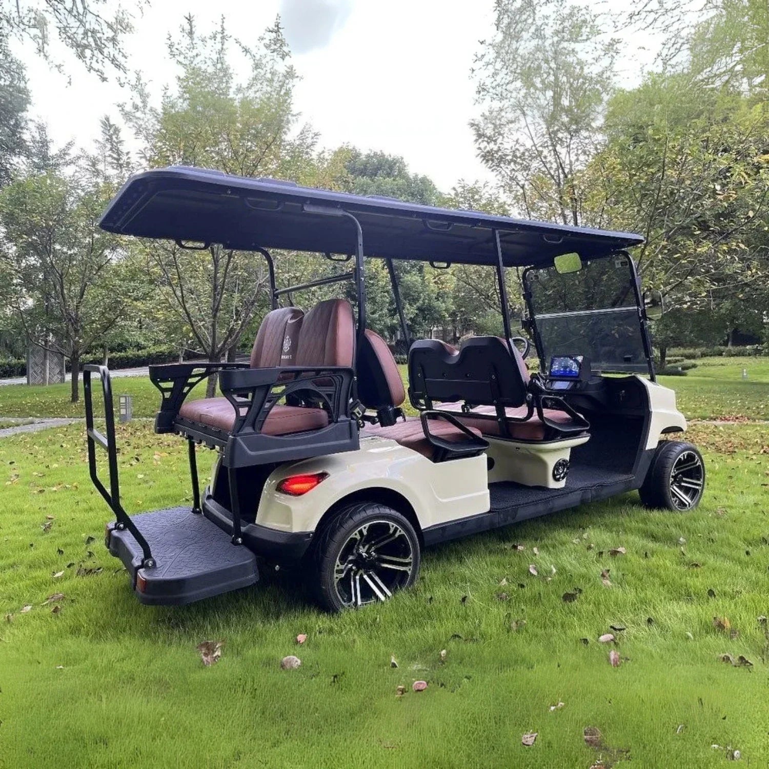 Golf cart on a grassy area with trees in the background