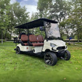 Golf cart on grass with trees in the background