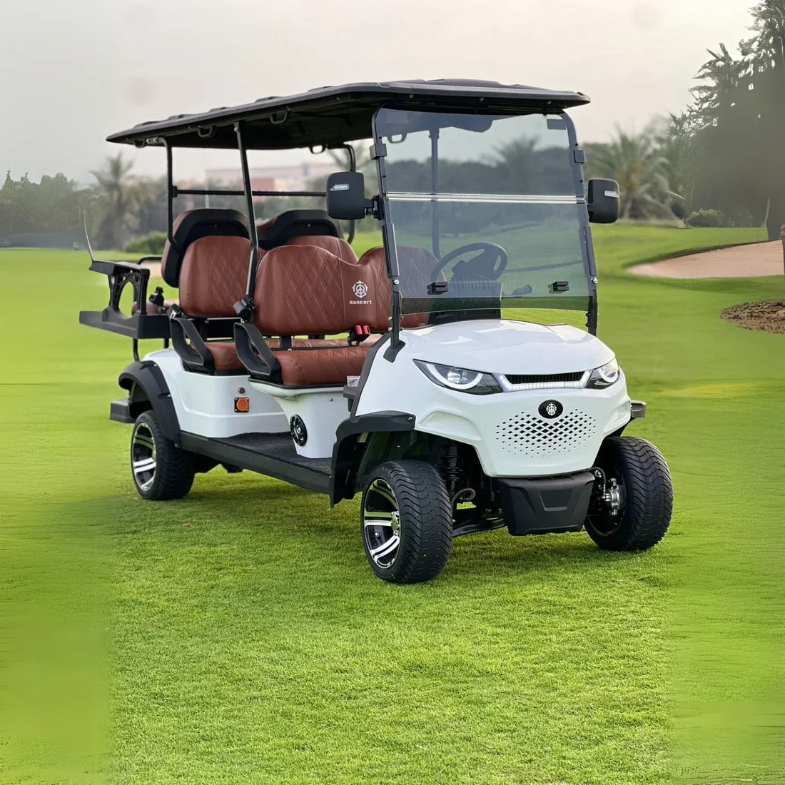 White golf cart with brown seats on a golf course