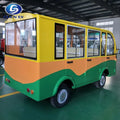 Small electric vehicle with a yellow and green color scheme in a warehouse setting.