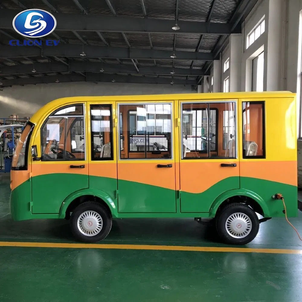 Small yellow and green bus inside a warehouse with a logo in the corner.