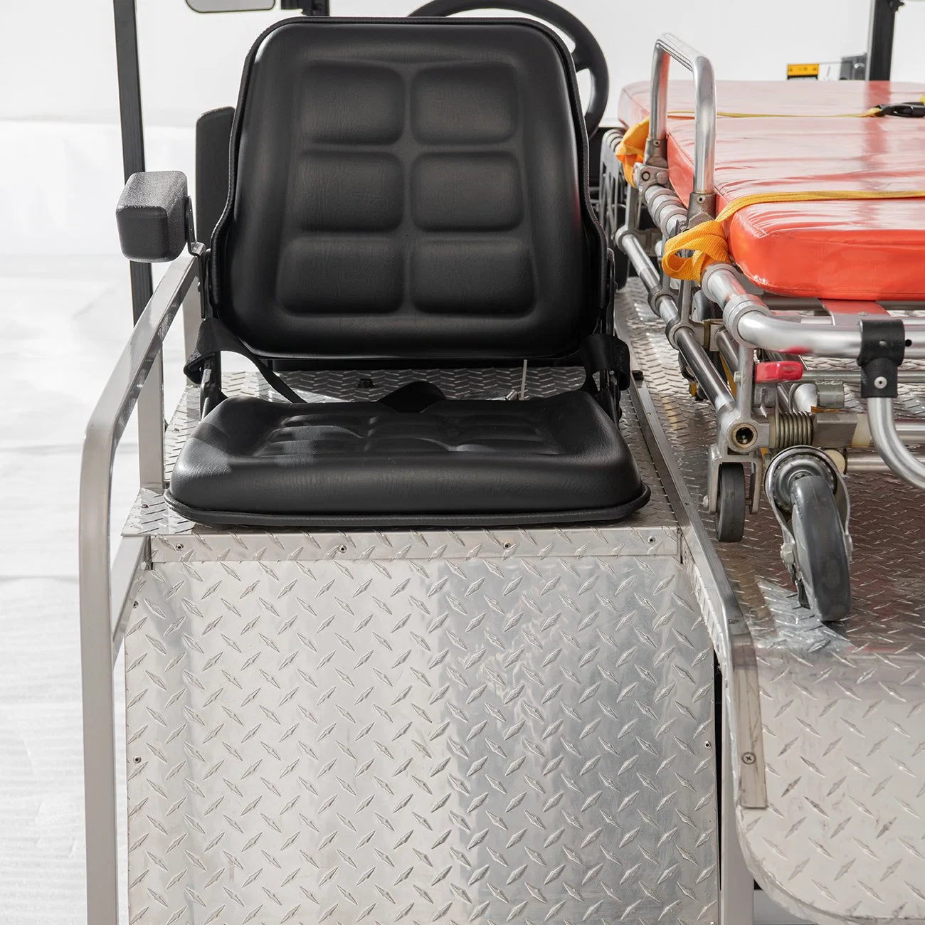 Black seat on a piece of industrial equipment with a white background