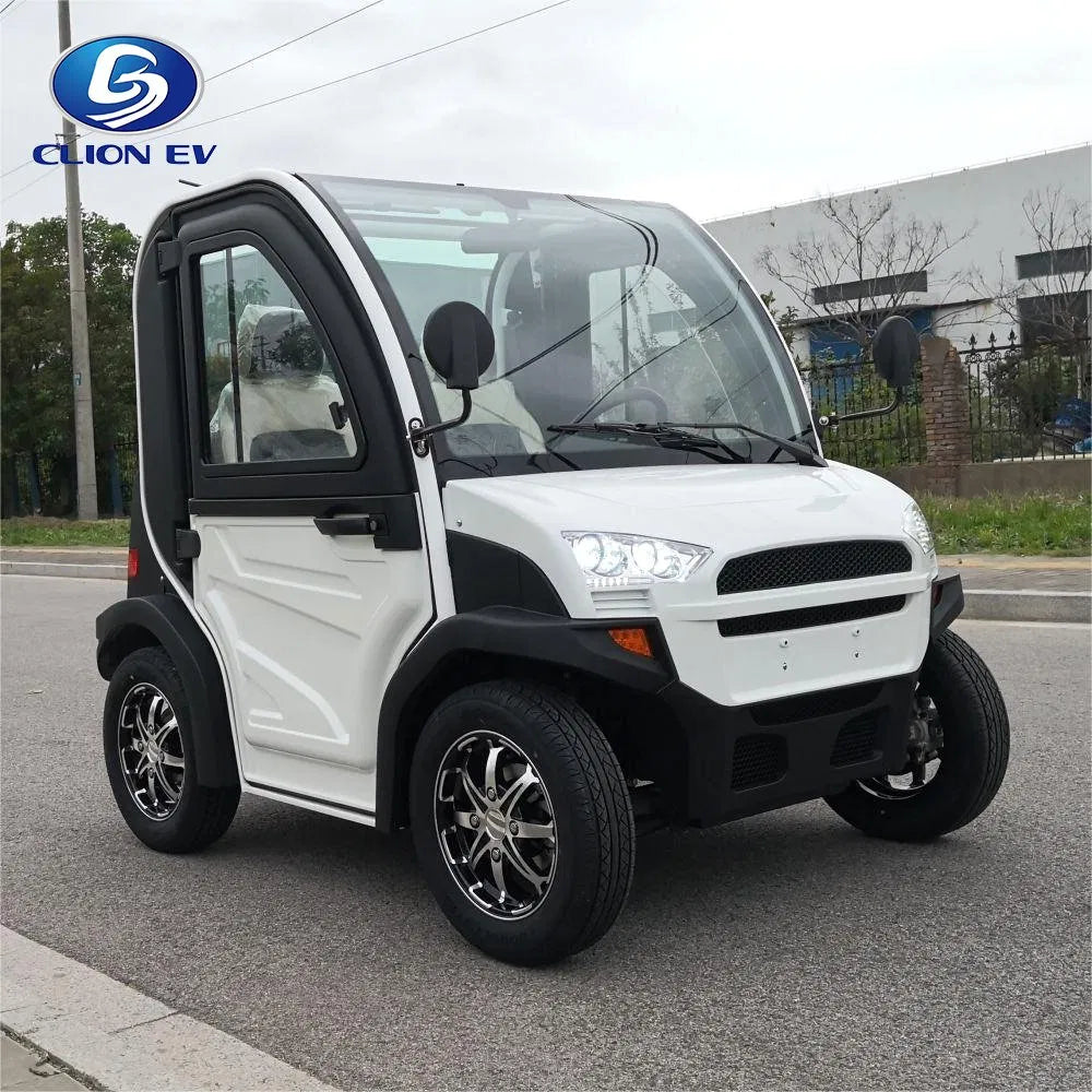 ocean cartz three-quarter front view of a white and black two-seater electric vehicle with a fully enclosed cab and a curved glass roof. This modern compact NEV or low-speed electric car is parked on an asphalt street, featuring black trim, a large windshield, and black fender flares. It is equipped with custom black and chrome alloy wheels, highlighting its all-weather neighborhood electric car design.