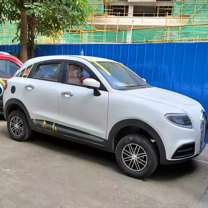 White SUV parked on a street with construction barriers in the background