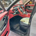 Car interior with a focus on the steering wheel and dashboard.