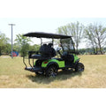 Green golf cart on a grassy field with trees in the background