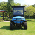 Blue utility vehicle on a grassy area with trees in the background