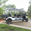White and black golf cart with open roof on a paved path in a park-like setting.