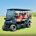 Golf cart with orange seats on a grassy field