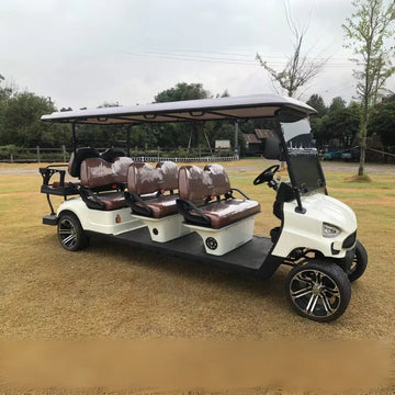 White electric golf cart with brown upholstered seats and black alloy wheels.